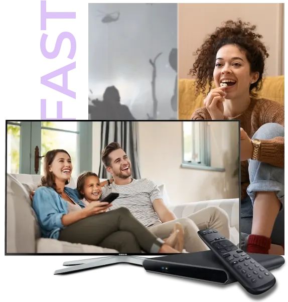 A girl is sitting on a couch watching tv that shows a family. Also shows, a remote and device